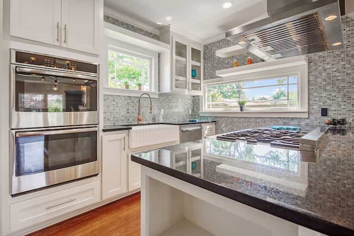 An image of a modern kitchen with sleek appliances, featuring a gas stove, refrigerator, and built-in microwave in Binghamton